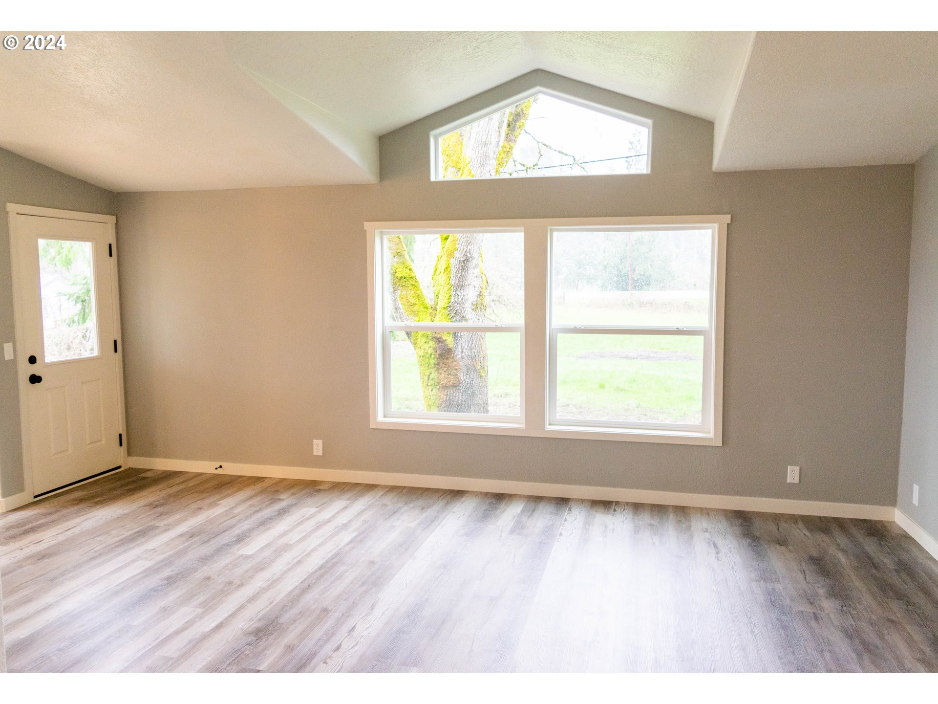 28157 Cottage Grove Lorane Road Cottage Grove, OR 97424 - Photo 4 of 33 an empty room with wooden floor and windows