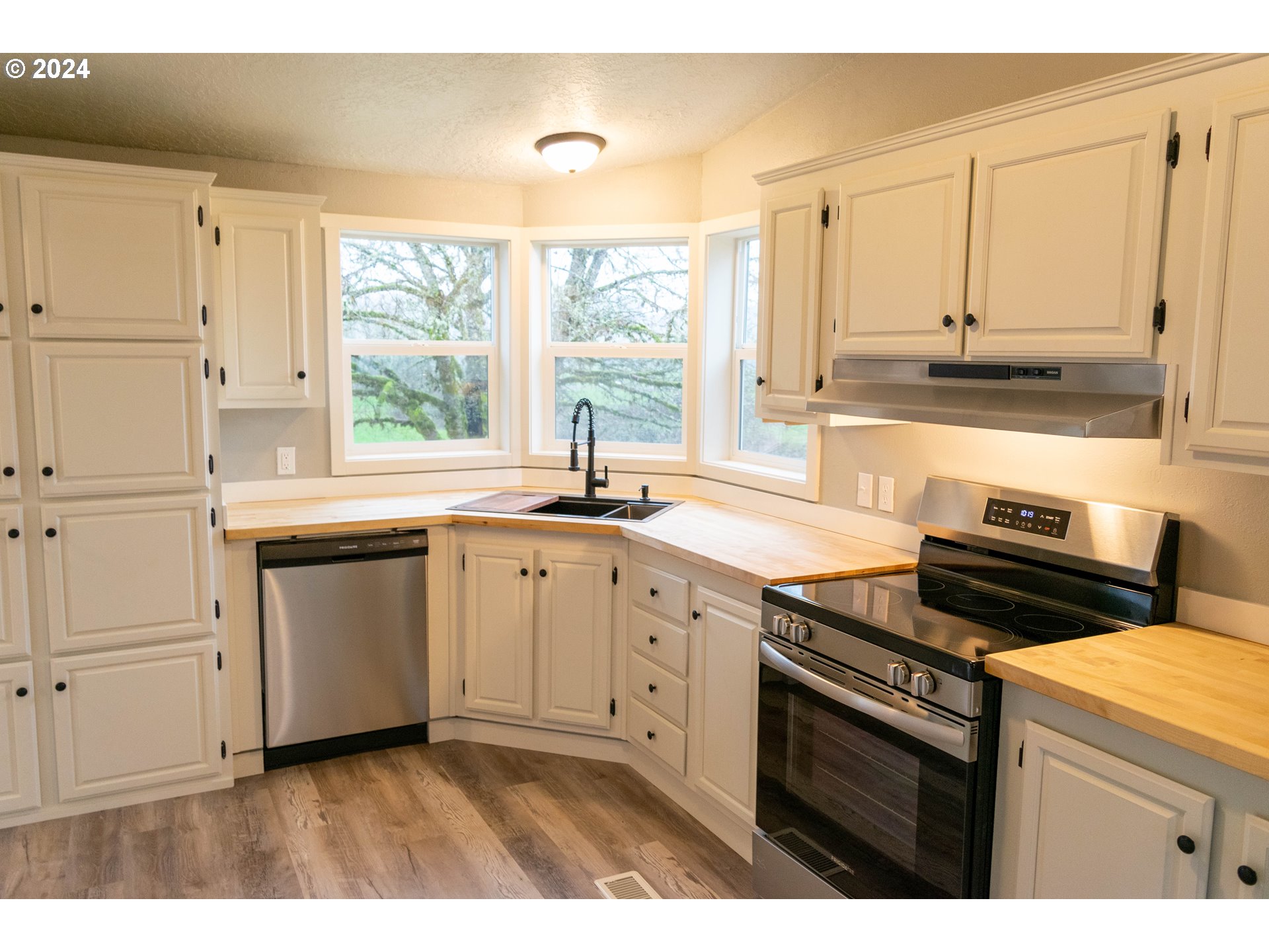 28157 Cottage Grove Lorane Road Cottage Grove, OR 97424 - Photo 7 of 33 a kitchen with a sink stove top oven and cabinets