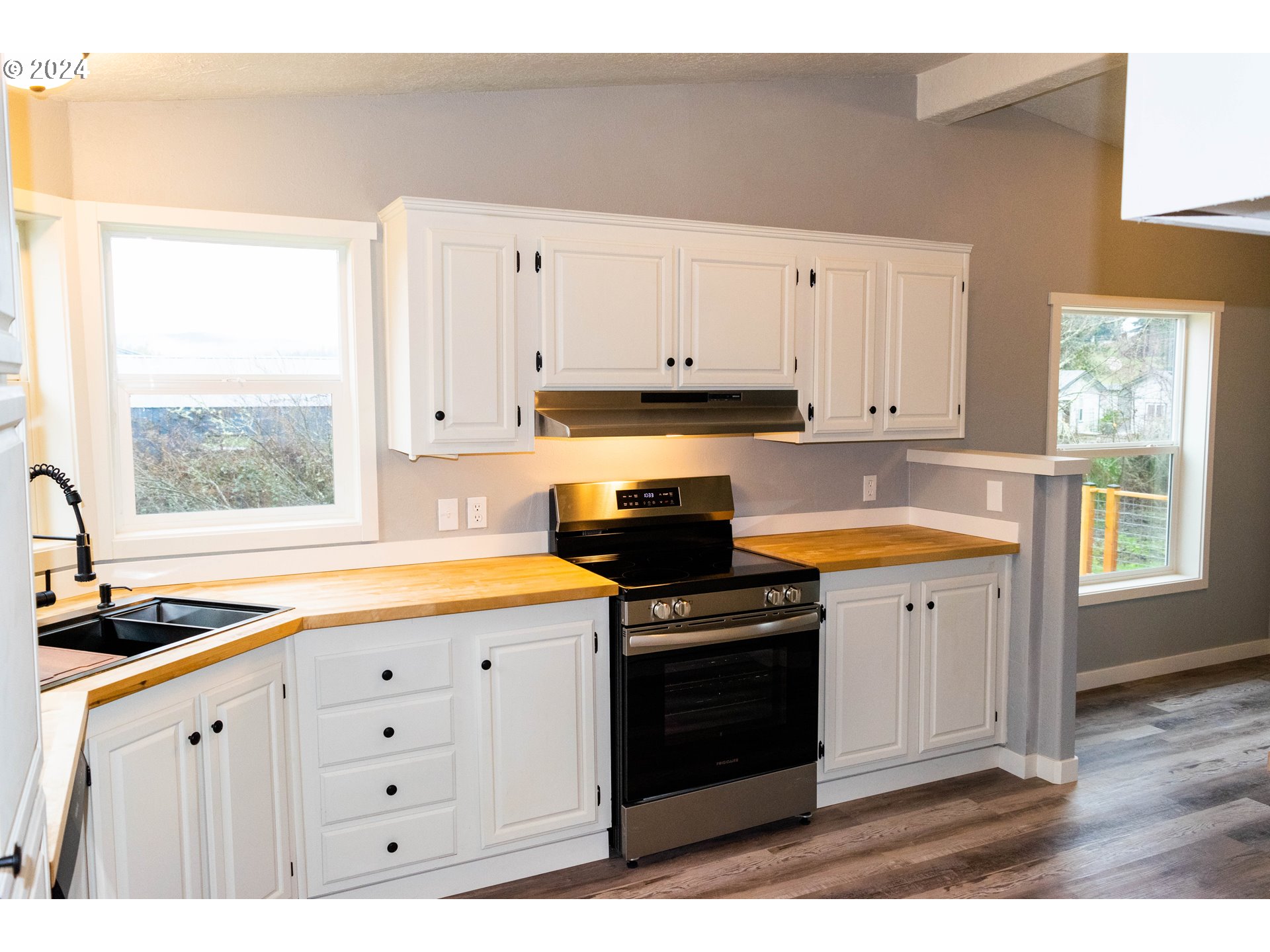 28157 Cottage Grove Lorane Road Cottage Grove, OR 97424 - Photo 9 of 33 a kitchen with granite countertop white cabinets and window