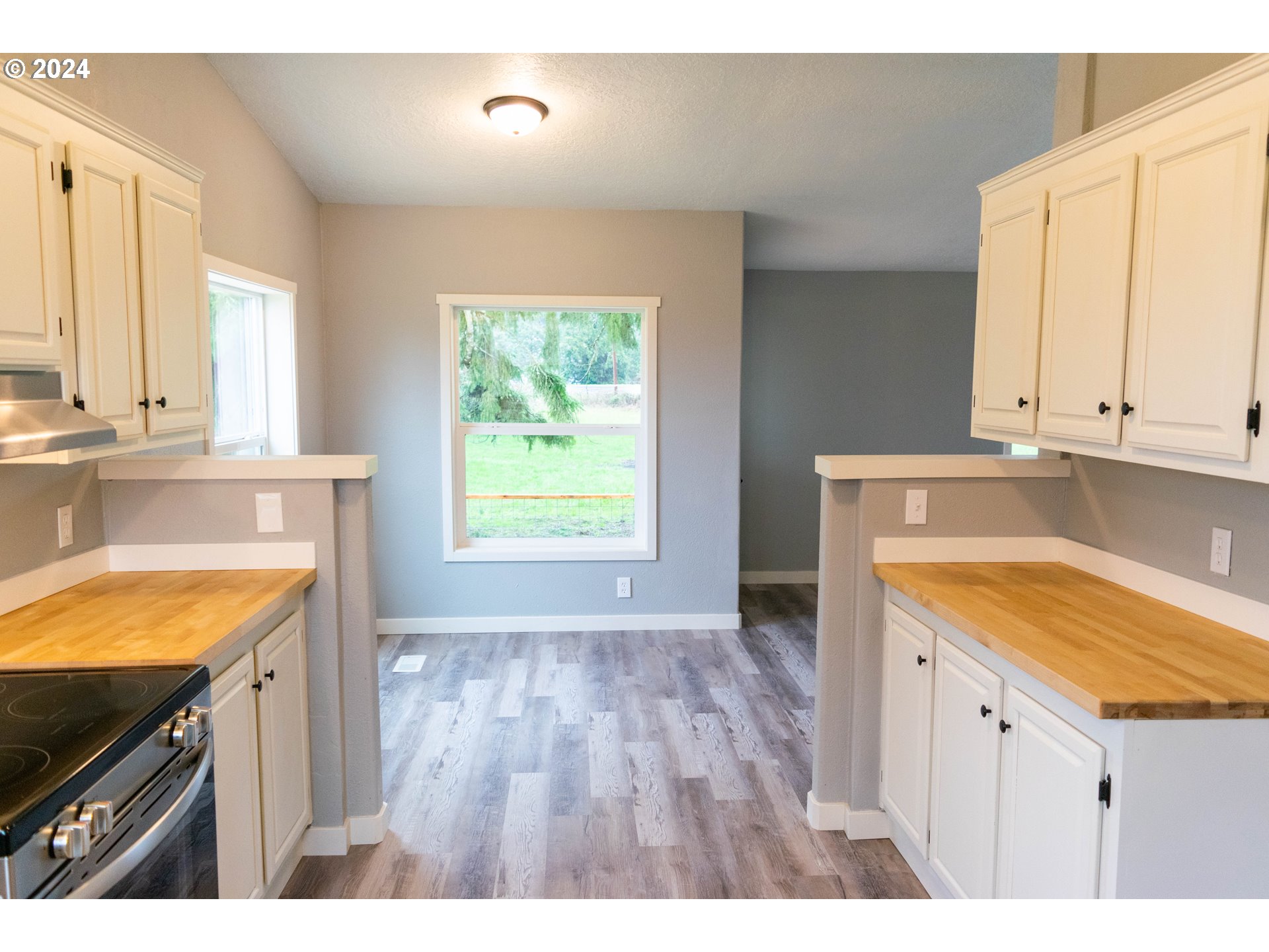 28157 Cottage Grove Lorane Road Cottage Grove, OR 97424 - Photo 10 of 33 a kitchen with a sink stove and cabinets