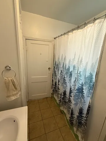 a bathroom with a shower and a tub