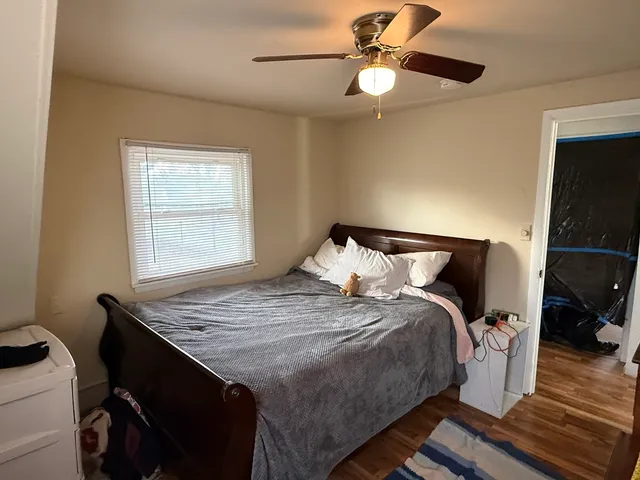 a bed sitting in a bedroom next to a window