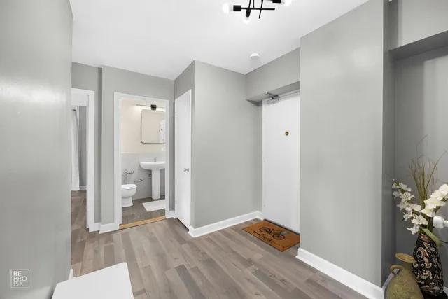 a view of a bathroom with a hardwood floor and a sink