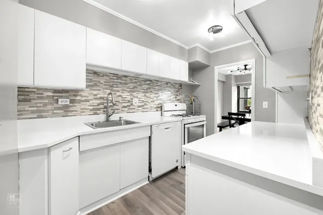 a kitchen with sink cabinets and appliances
