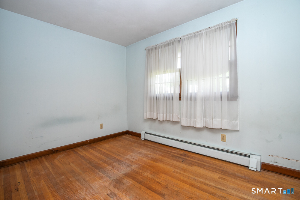 64 Somer Drive Meriden, CT 06451 - Photo 20 of 28 a view of an empty room with wooden floor and a window