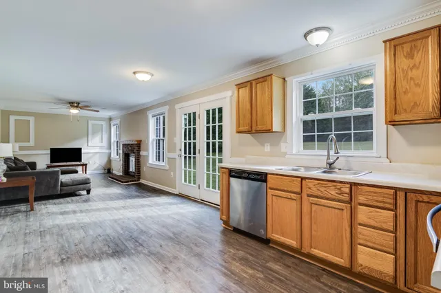 a large kitchen with kitchen island granite countertop a large window and a sink