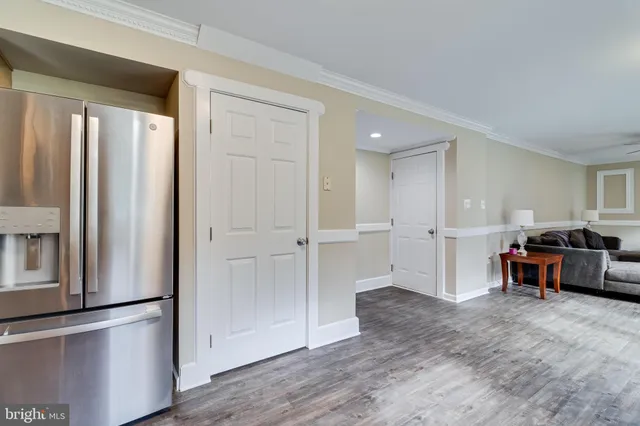 an empty room with wooden floor and furniture