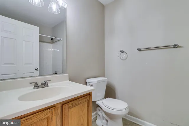 a bathroom with a sink toilet and a mirror