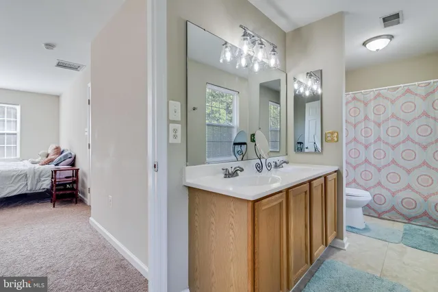 a en suite bathroom with a sink a mirror and a shower