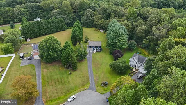 an aerial view of residential house with outdoor space and swimming pool