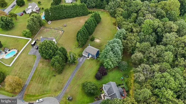 an aerial view of residential house with outdoor space and swimming pool