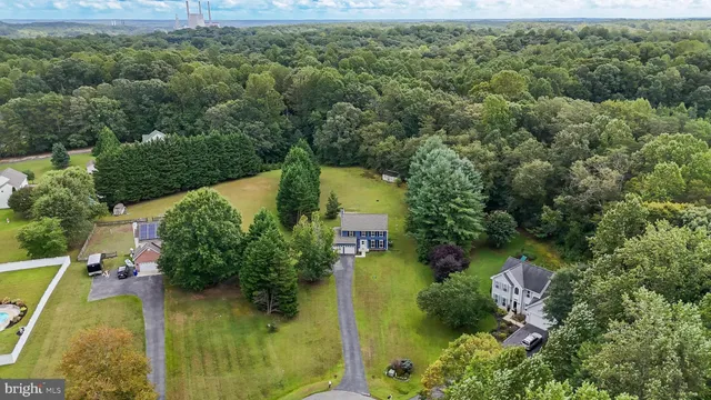 an aerial view of residential house with outdoor space and swimming pool