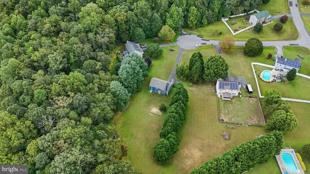 an aerial view of residential house with outdoor space and swimming pool