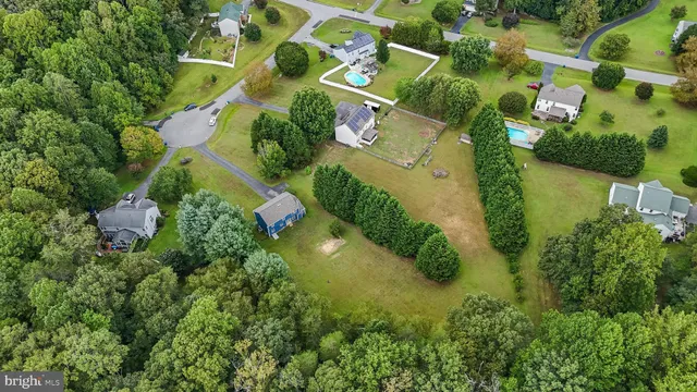 an aerial view of residential houses with outdoor space and street view