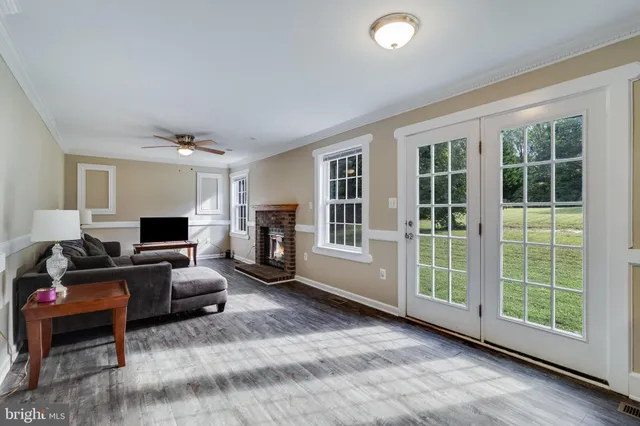 a living room with furniture window and a flat screen tv