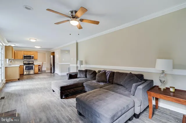 a living room with furniture and kitchen view