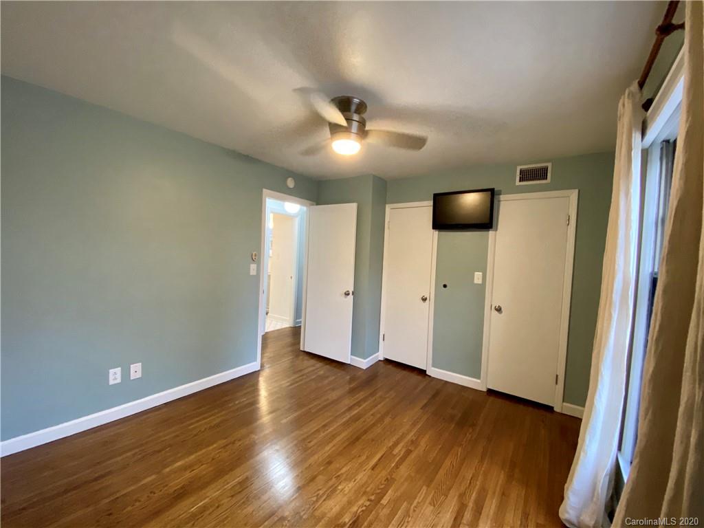 4317 Walker Road, Unit B Charlotte, NC 28211 - Photo 15 of 25 an empty room with wooden floor and a ceiling fan