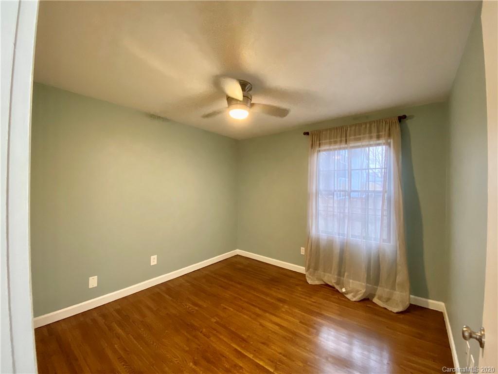4317 Walker Road, Unit B Charlotte, NC 28211 - Photo 16 of 25 an empty room with windows and ceiling fan