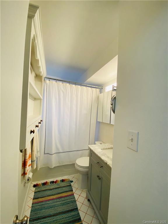 4317 Walker Road, Unit B Charlotte, NC 28211 - Photo 17 of 25 a bathroom with a sink a toilet and shower curtain