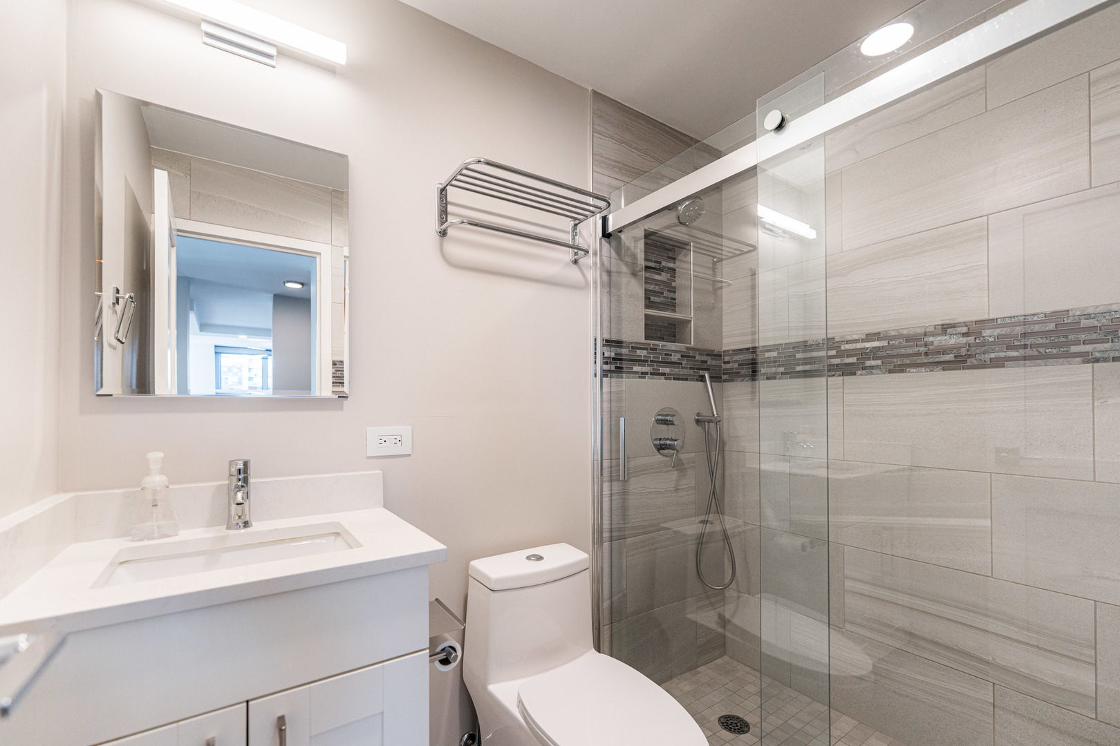 400 East Randolph Street, Unit 3629 Chicago, IL 60601 - Photo 16 of 36 a bathroom with a granite countertop sink toilet a mirror and shower