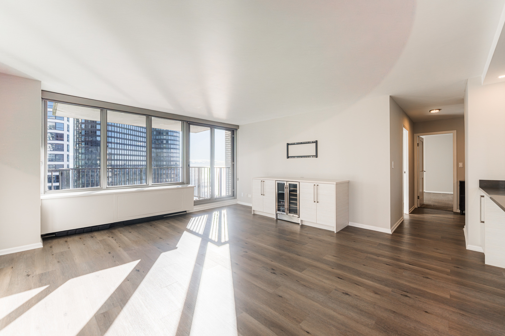 400 East Randolph Street, Unit 3629 Chicago, IL 60601 - Photo 2 of 36 a view of empty room with wooden floor and fireplace