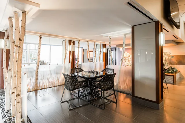 a view of a kitchen with stainless steel appliances granite countertop a stove a sink and a microwave