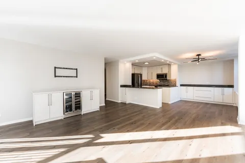 a view of kitchen with microwave and refrigerator