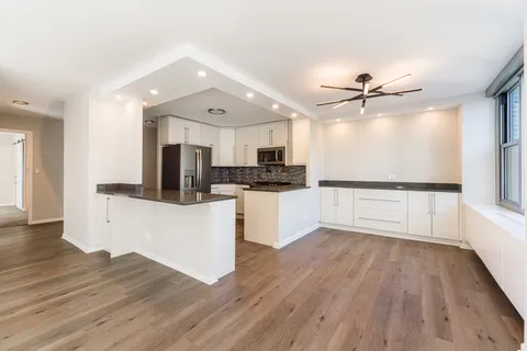 a view of kitchen with microwave and wooden floor