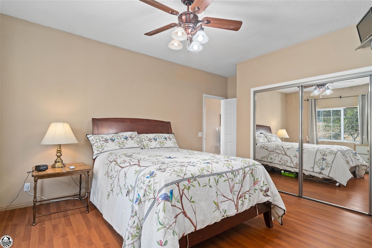 3102 Quail Hill Road Copperopolis, CA 95228 - Photo 20 of 60 a bedroom with a bed and a table