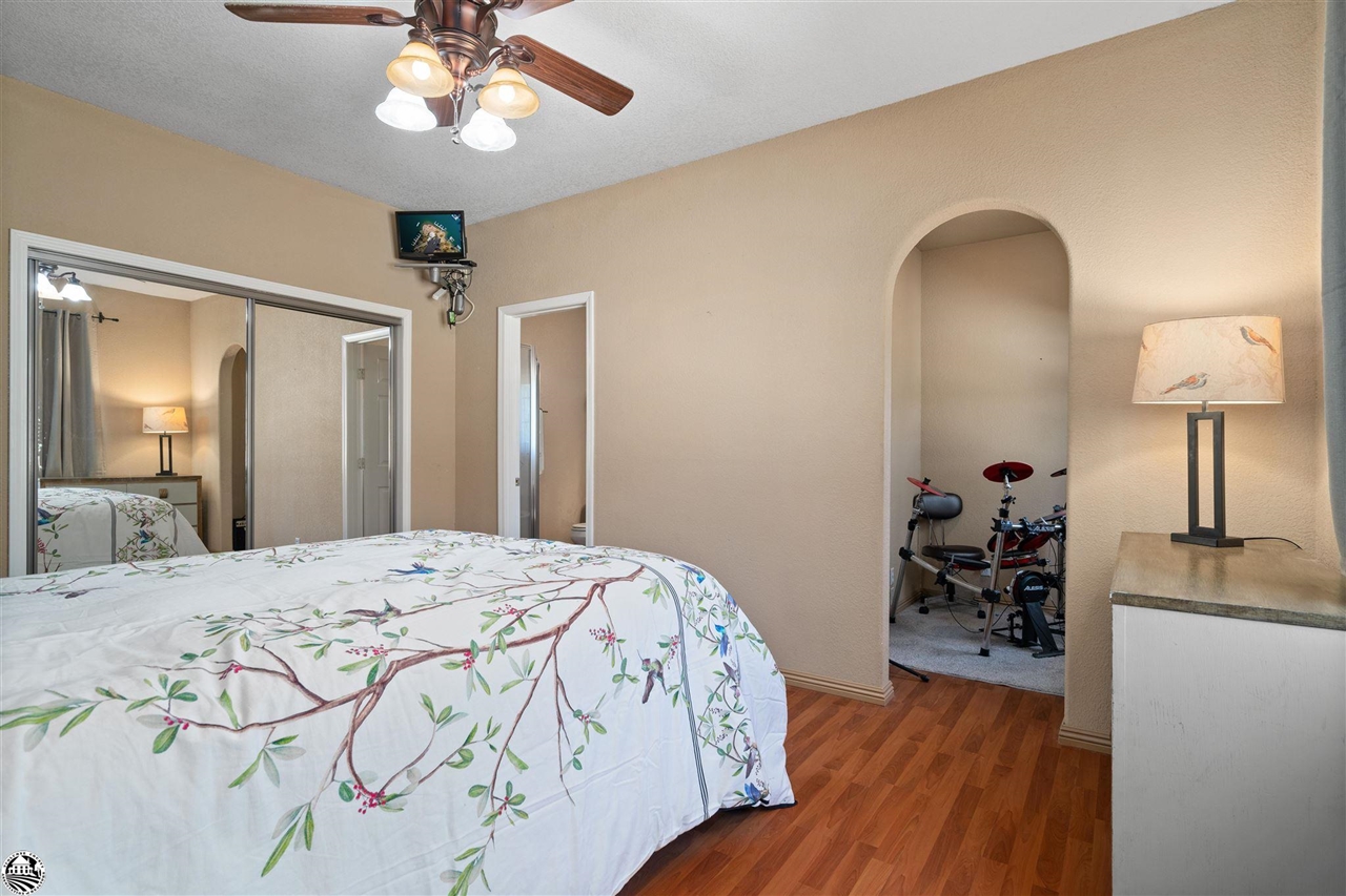 3102 Quail Hill Road Copperopolis, CA 95228 - Photo 21 of 60 a bedroom with a bed and a chandelier
