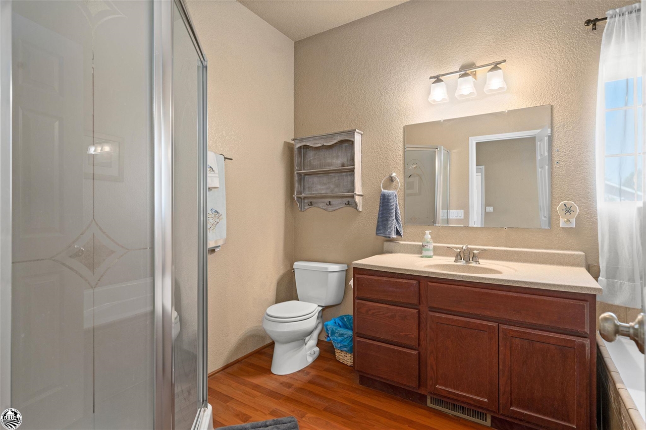 3102 Quail Hill Road Copperopolis, CA 95228 - Photo 23 of 60 a bathroom with a double vanity sink toilet and mirror