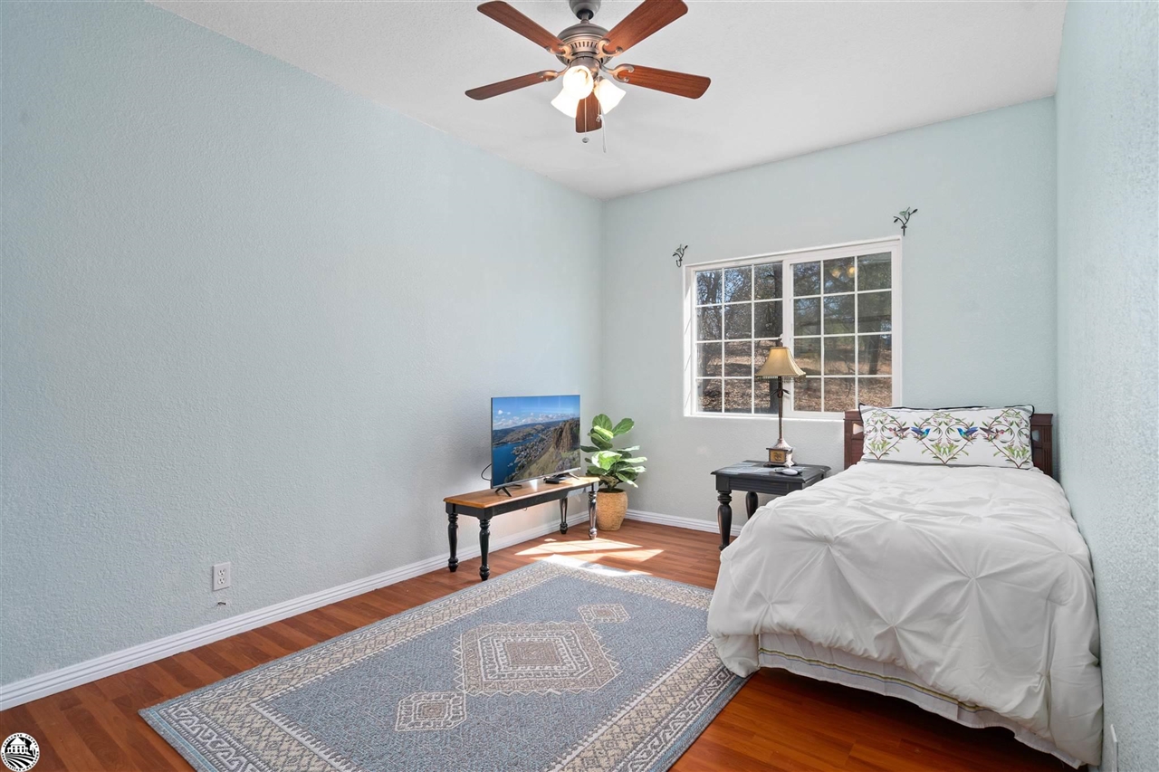 3102 Quail Hill Road Copperopolis, CA 95228 - Photo 27 of 60 a bedroom with a bed window and a table