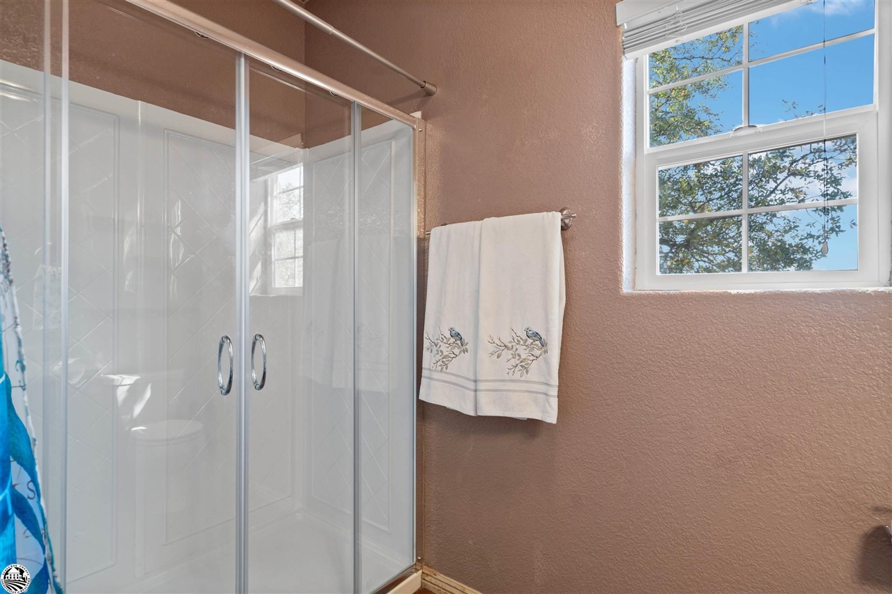 3102 Quail Hill Road Copperopolis, CA 95228 - Photo 32 of 60 a bathroom with a shower and a window