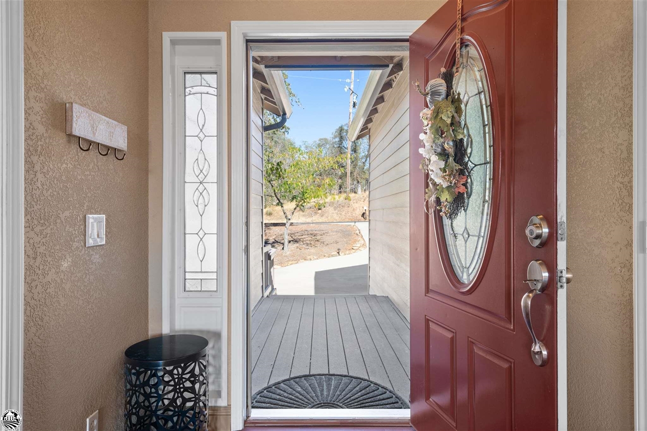 3102 Quail Hill Road Copperopolis, CA 95228 - Photo 5 of 60 a view of a hallway with wooden floor and a rug