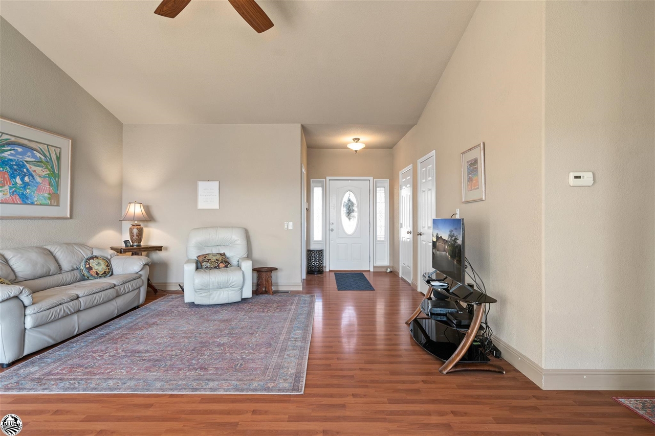 3102 Quail Hill Road Copperopolis, CA 95228 - Photo 8 of 60 a living room with furniture hard wood floor and a ceiling fan