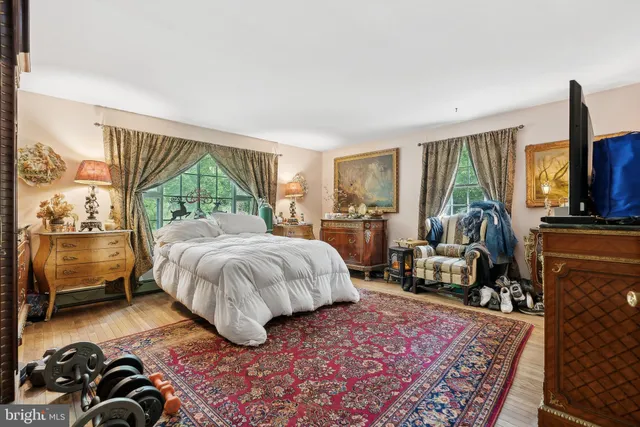 a view of a hallway with wooden floor and a living room