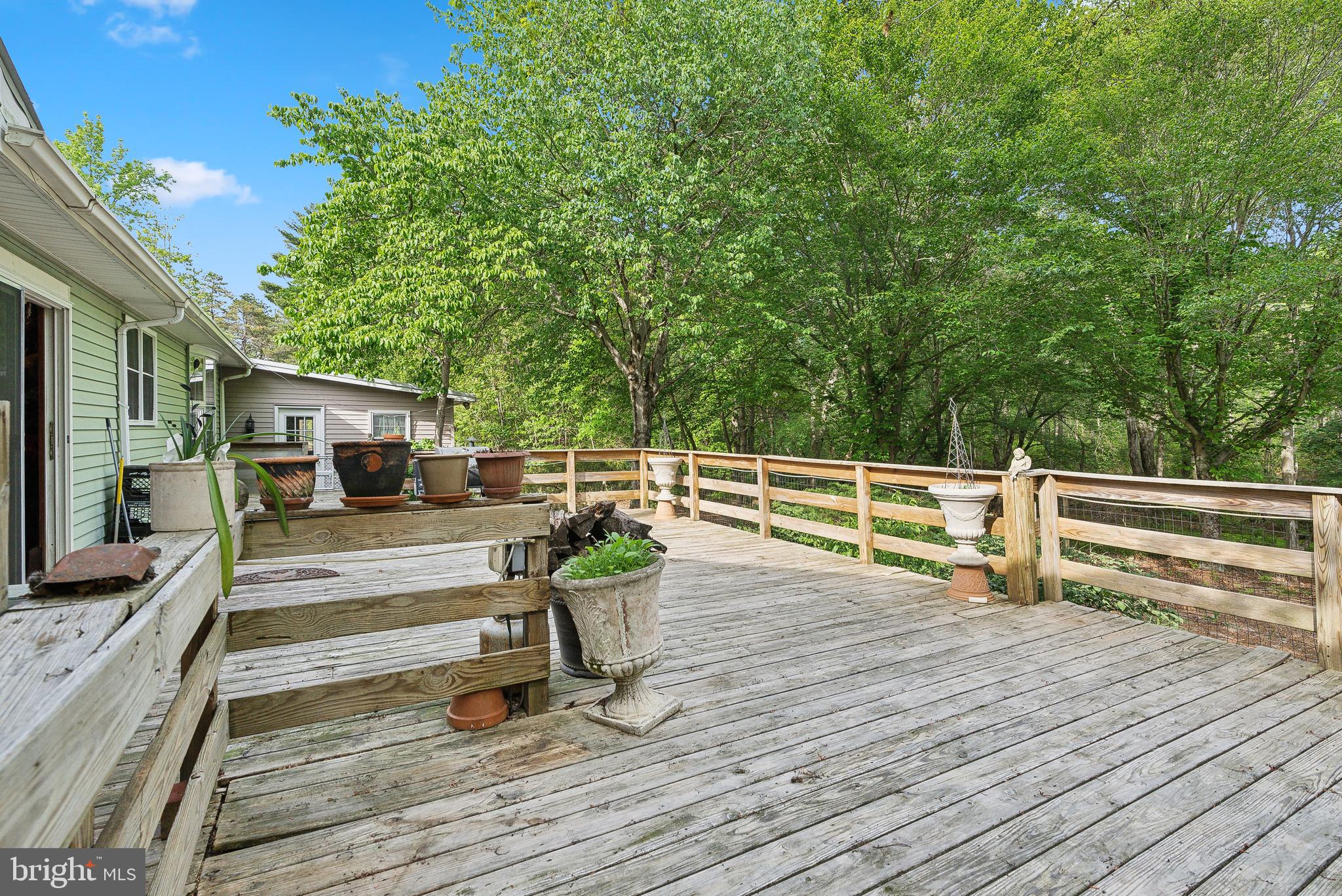 305 Hopewell Road Medford, NJ 08055 - Photo 23 of 30 a view of a deck with table and chairs a barbeque with wooden floor and fence
