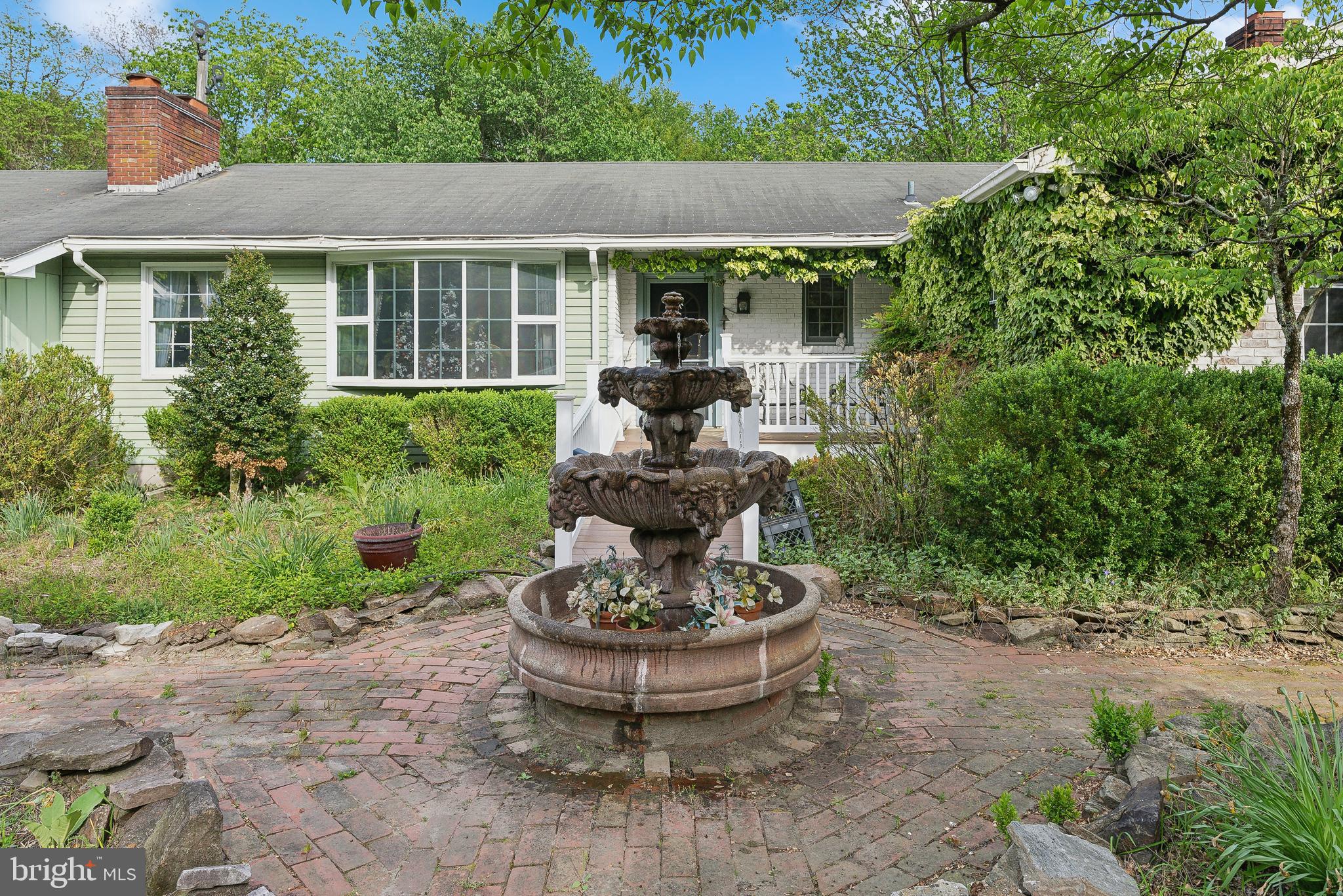 305 Hopewell Road Medford, NJ 08055 - Photo 4 of 30 a view of a backyard with plants and a fountain