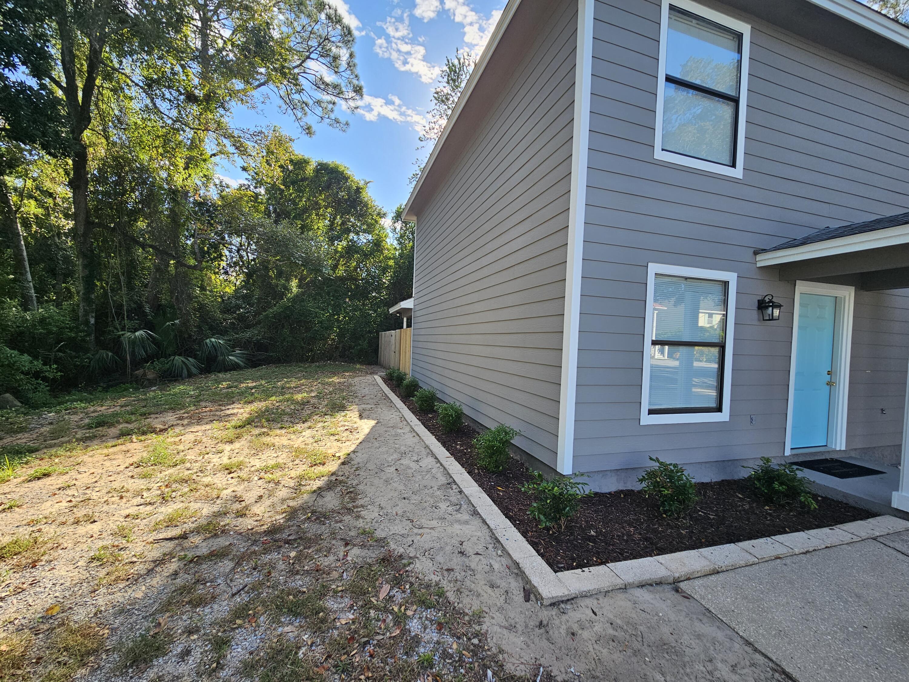 708 Bayshore Drive Niceville, FL 32578 - Photo 2 of 14 a view of yellow house with a yard