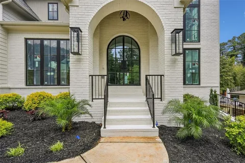 a front view of a house with a garden