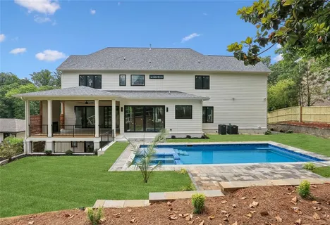 a front view of house with yard and swimming pool