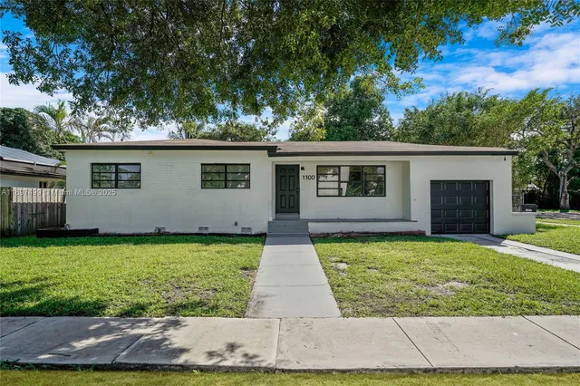 a view of backyard with garden and garage