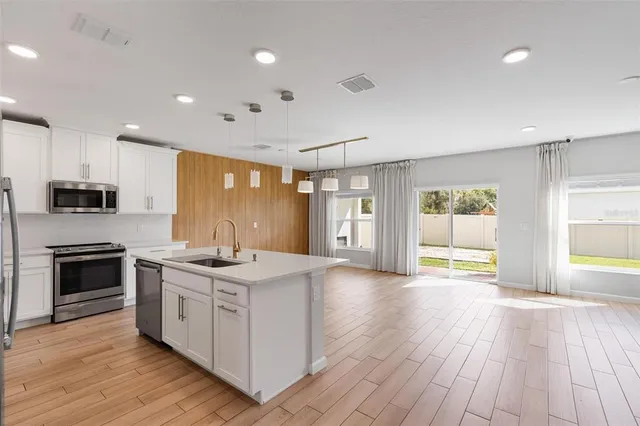 a kitchen with a sink and a mirror