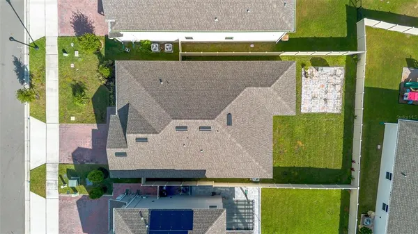 an aerial view of residential houses with outdoor space and street view