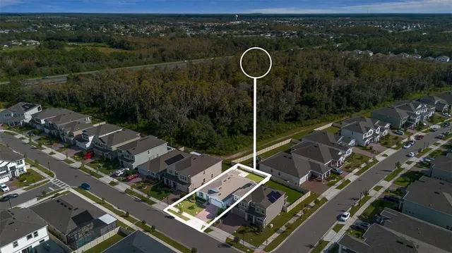 a view of a patio with couches chairs and a small yard
