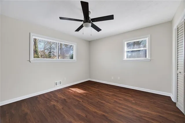 a view of empty room with wooden floor