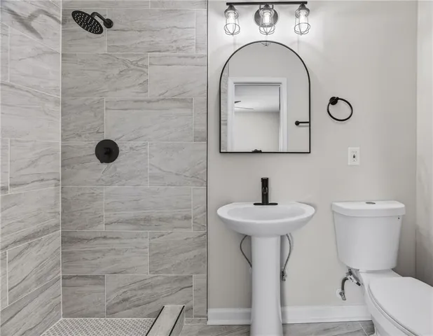 a bathroom with a sink a mirror and a shower
