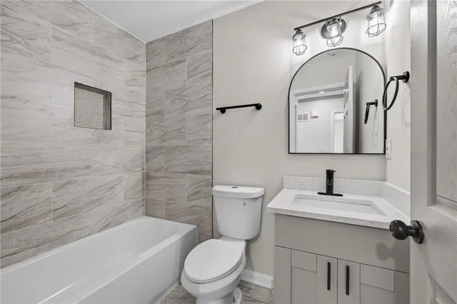 a bathroom with a toilet a sink and mirror