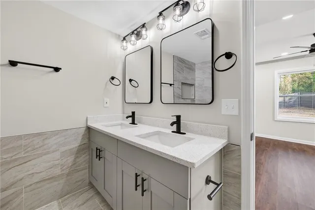 a bathroom with a double vanity sink mirror and