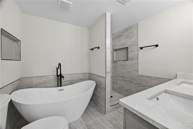 a white bath tub sitting next to a sink
